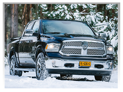 blue Ram truck driving in the snow